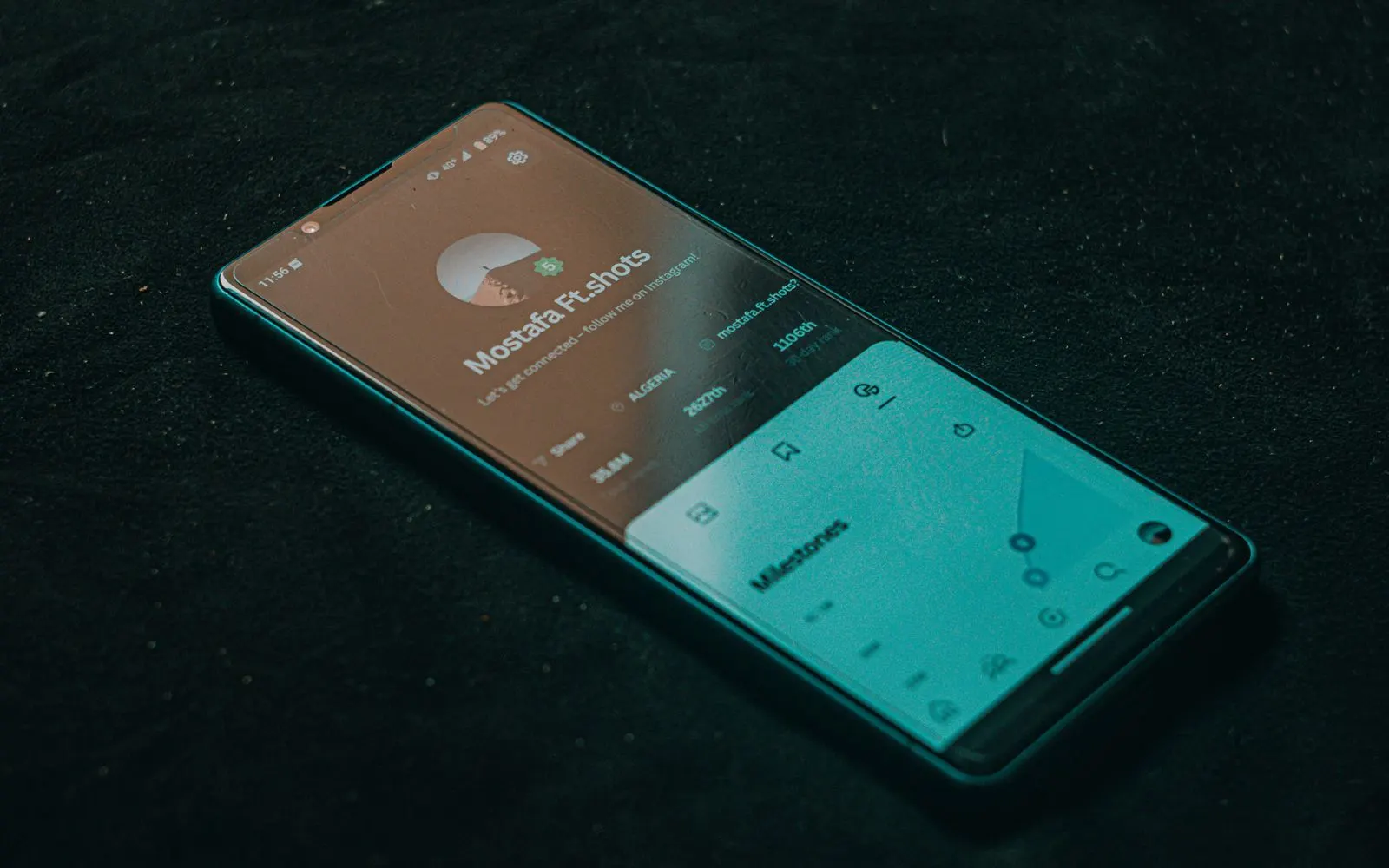 Smartphone showing an app on a dark surface